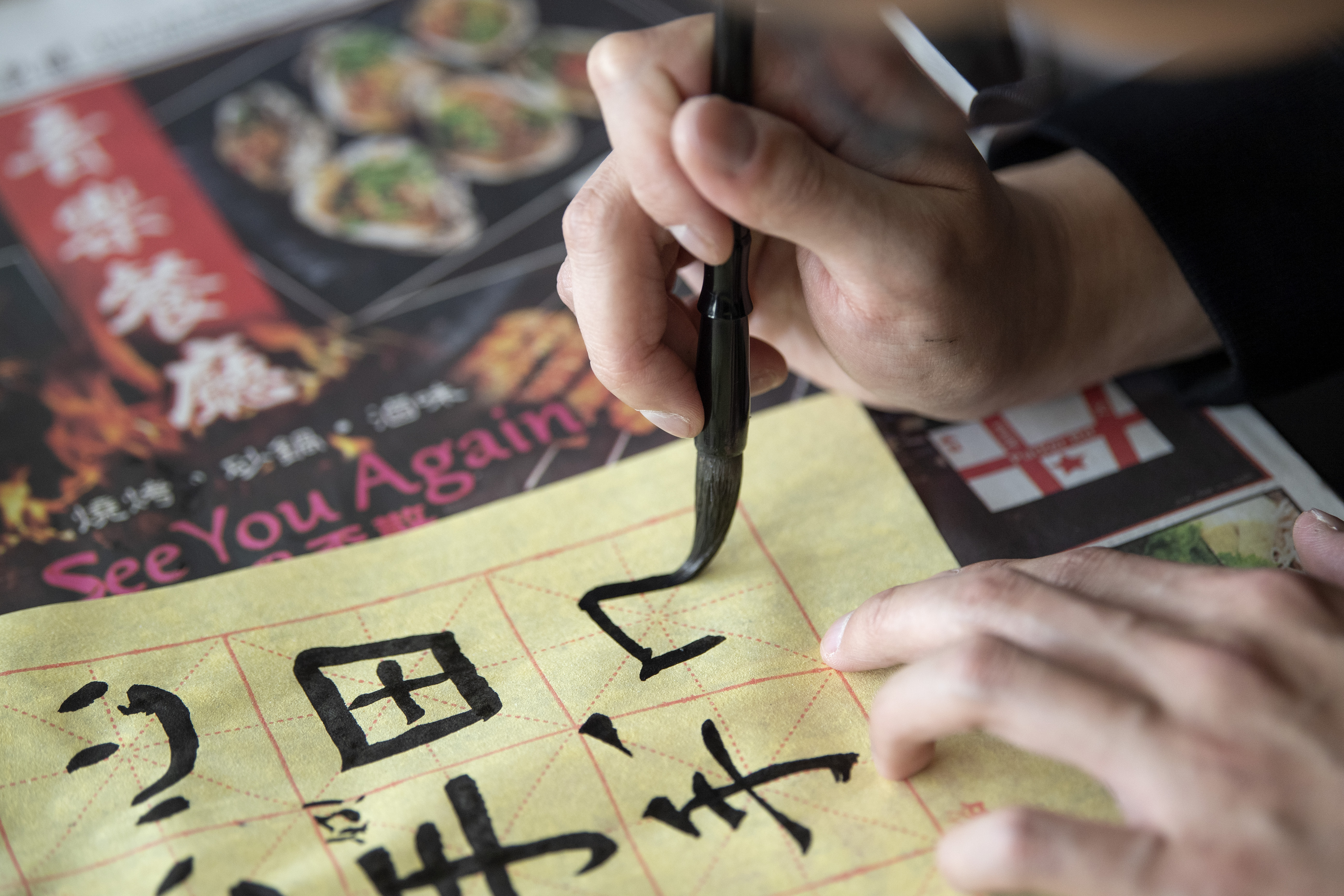A TCU student practices Chinese script