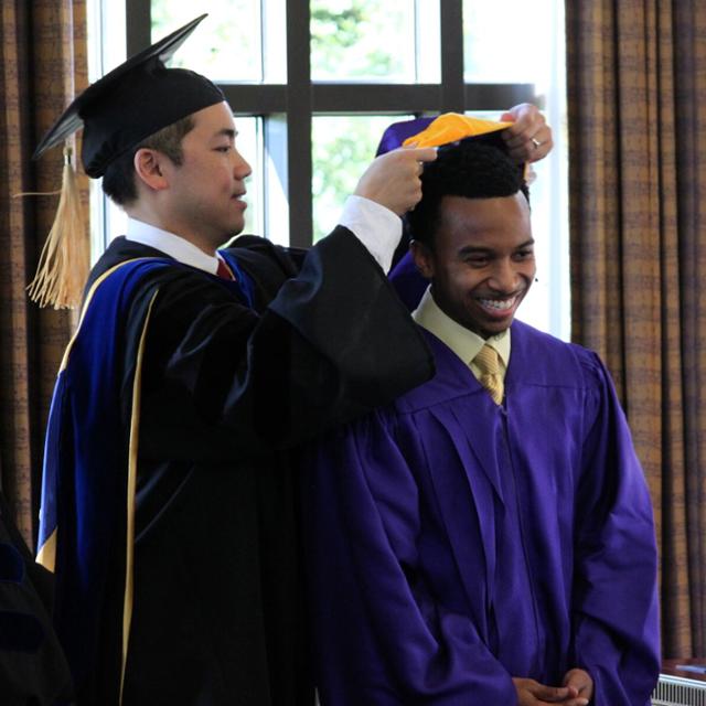 A student receives his master's hood
