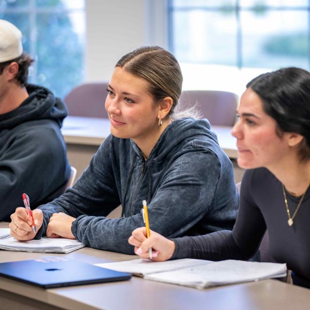 Students listen to professor during a lecture.