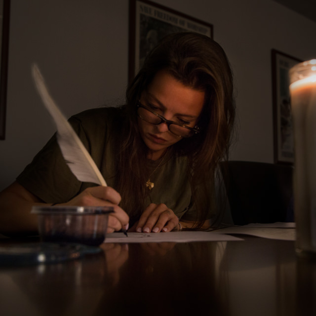 A student writes with a quill