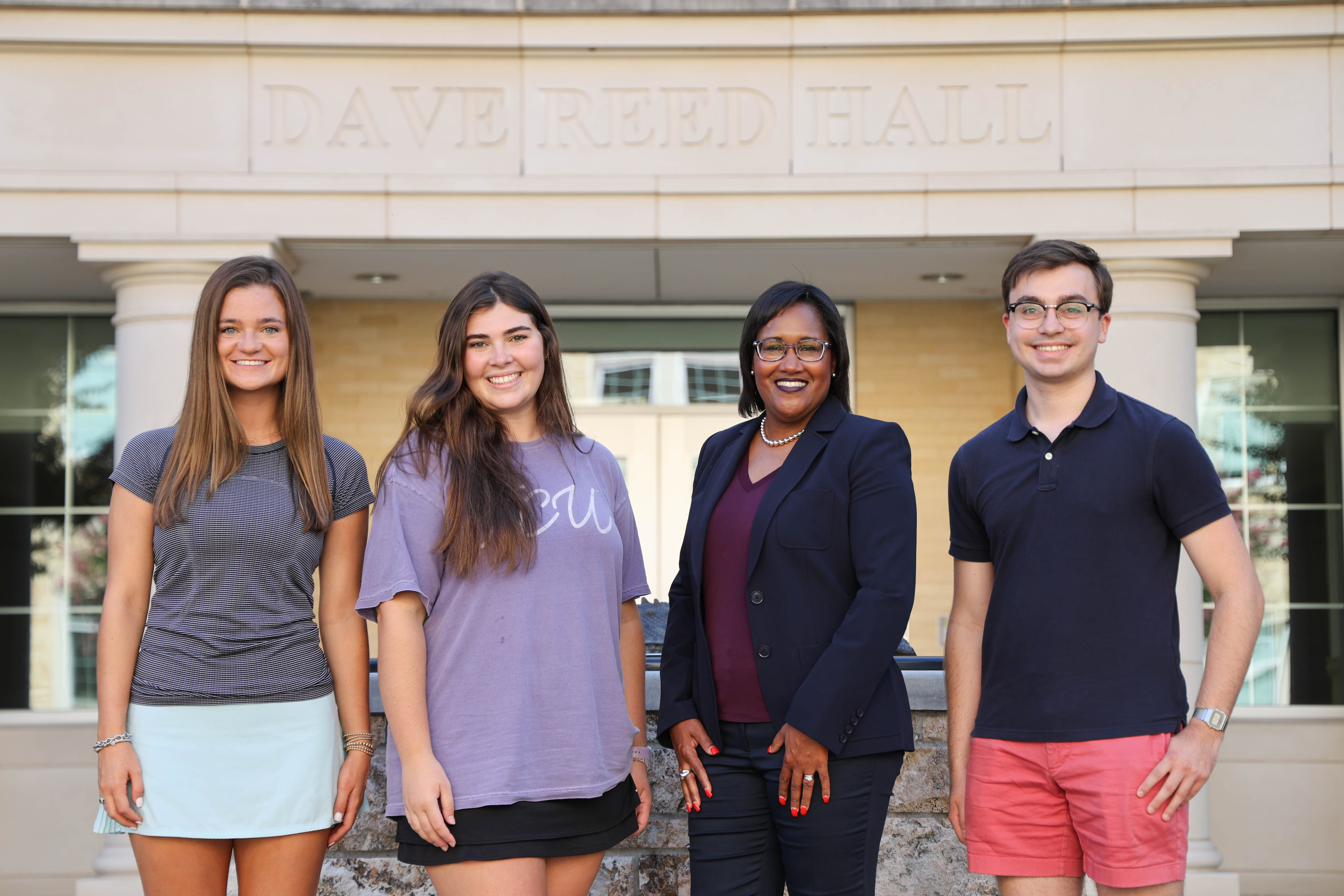  Dean of the AddRan College of Liberal Arts, Sonja Watson, poses for photos with AddRan students.