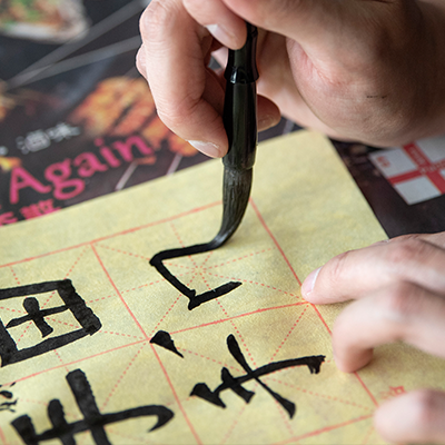 A student draws Chinese characters