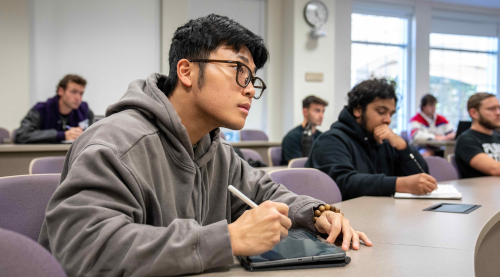 Student listens to professor in lecture