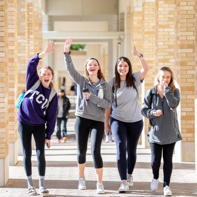 Students wave at the camera