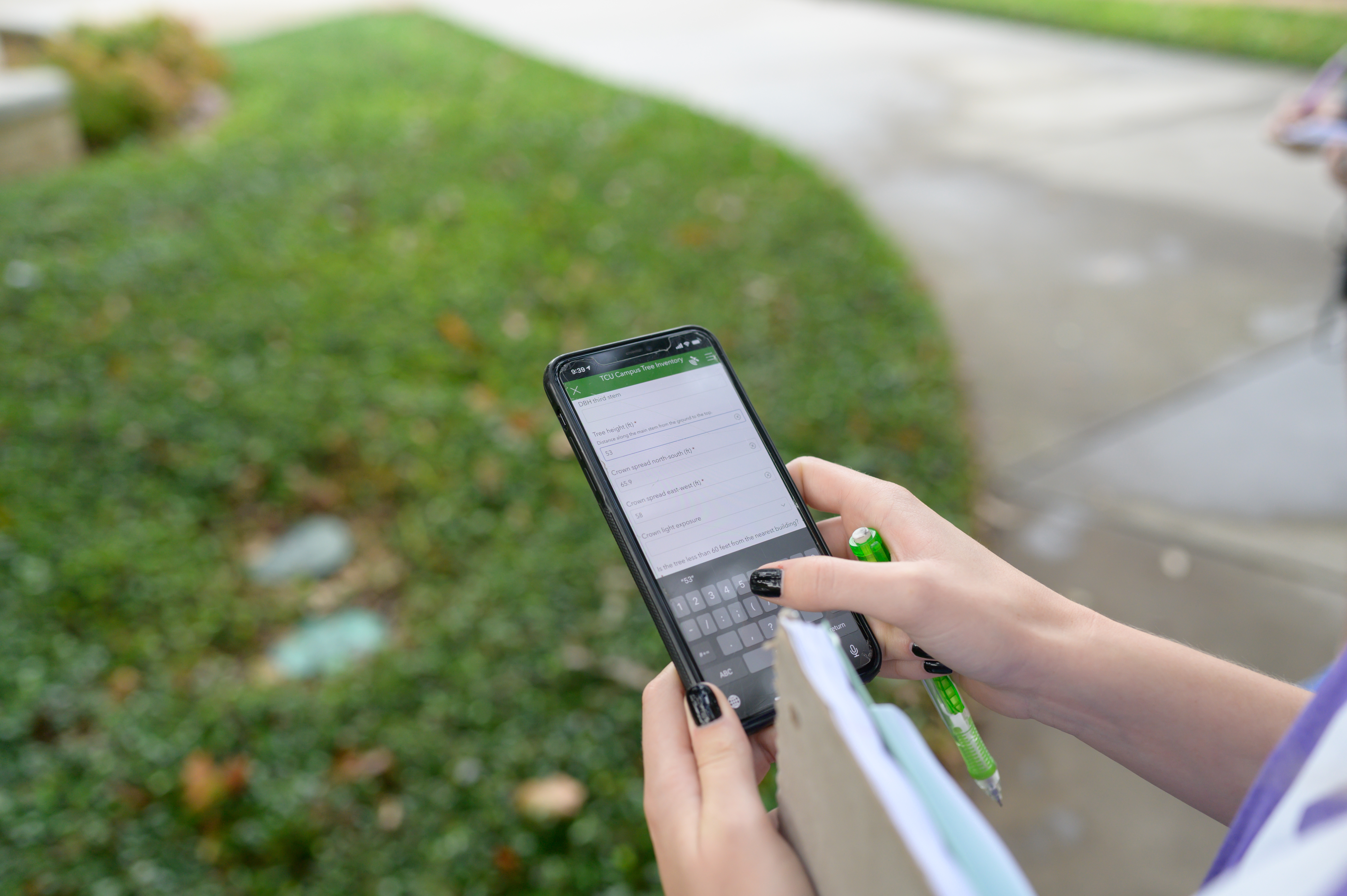 A student in Ashley Cole's, Ph.D., physical geography lab enters data for a tree inventory of TCU's campus in 2021. Credit TCU Marketing and Communication | Eric Sasadeusz