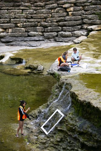 Students work along the trinity river