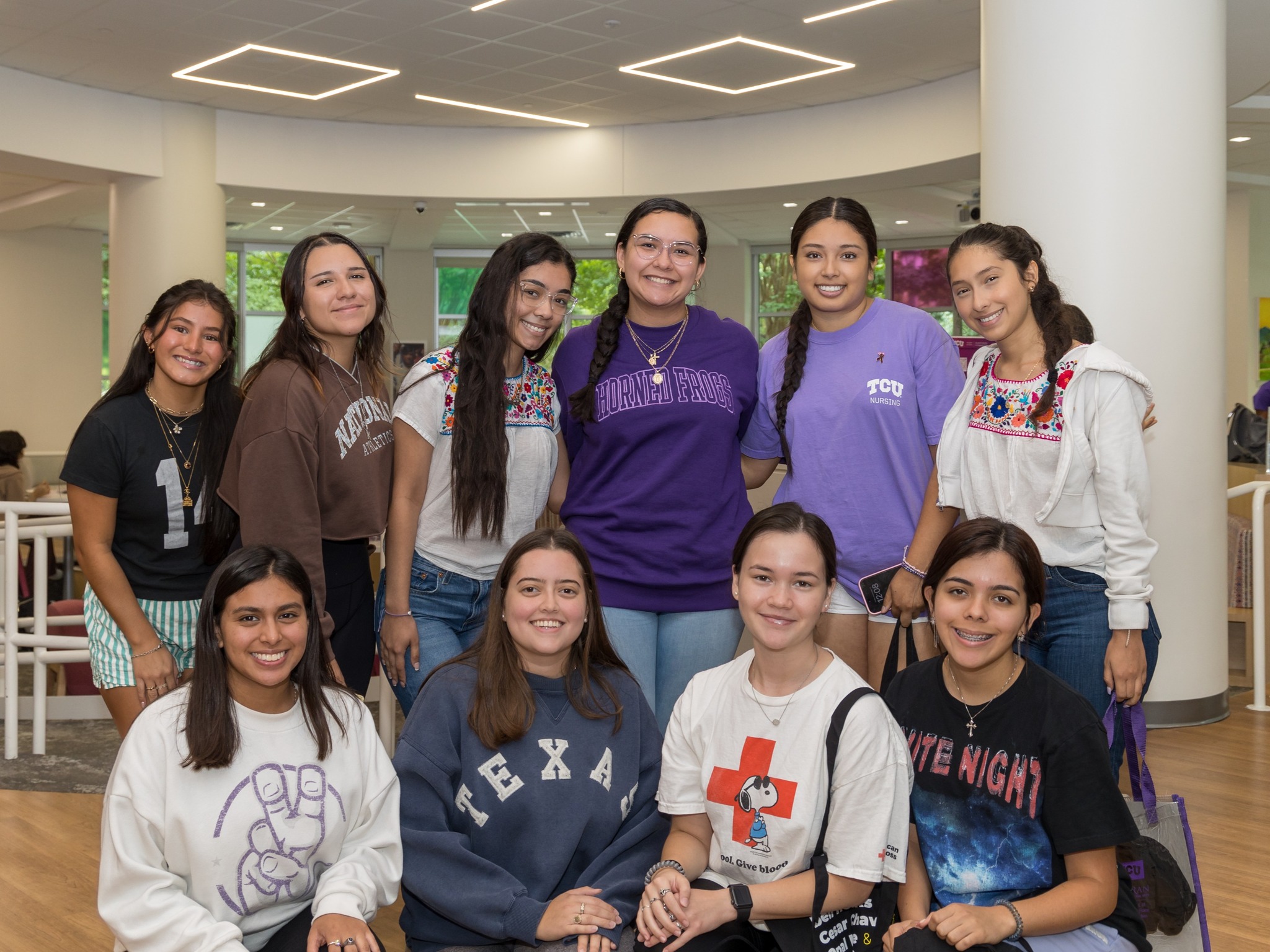 Students smiling in a group and posing for a picture.