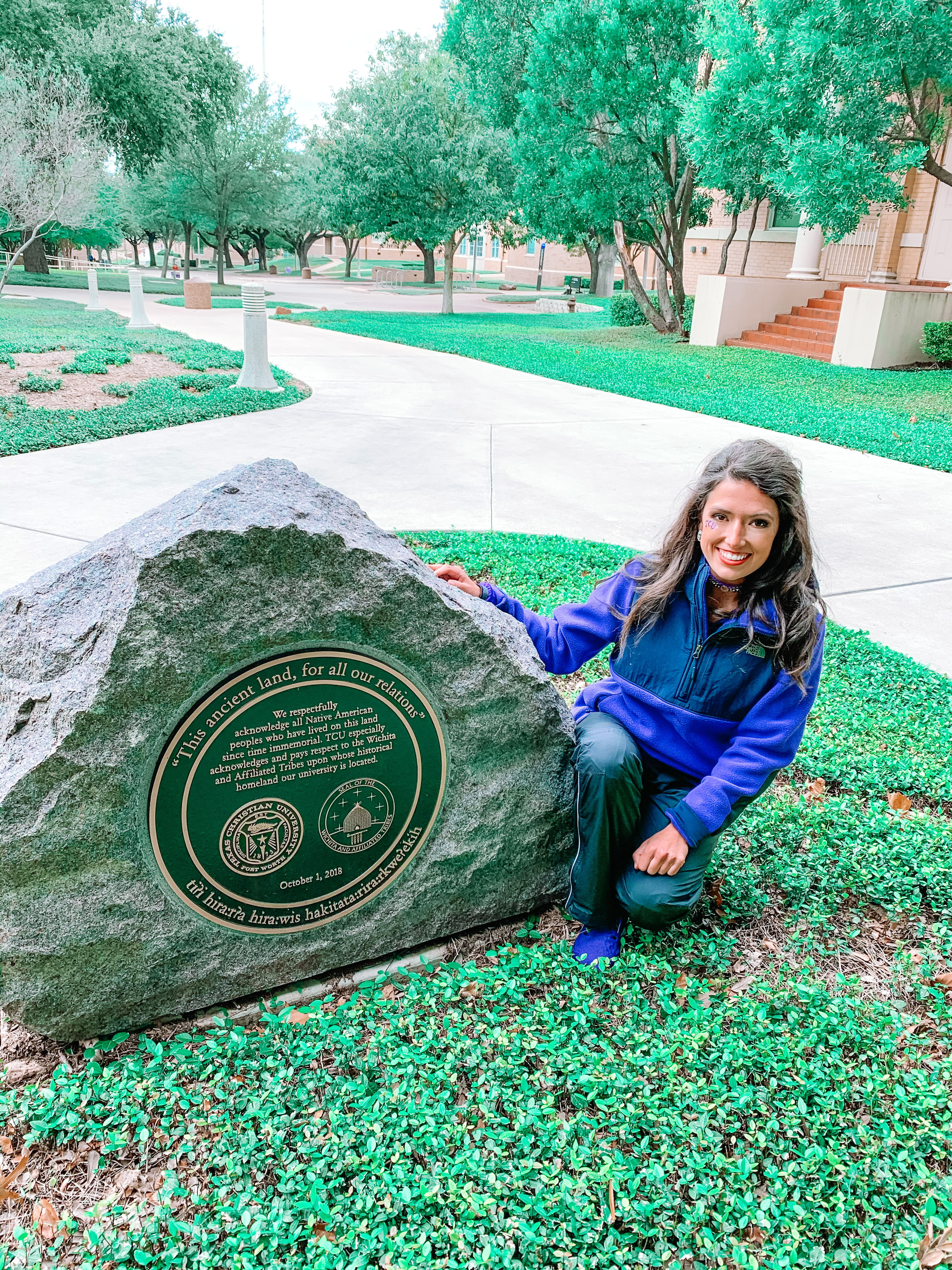 Chiariello poses with the TCU Native American Land Monument. 