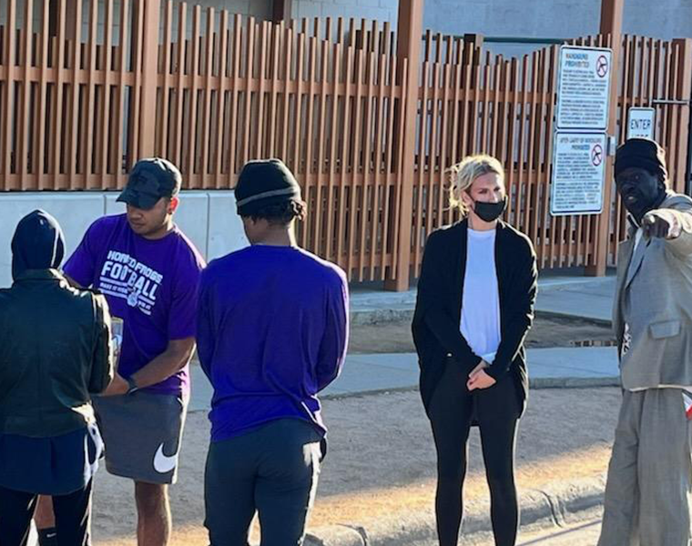 Harris College MSW student Ashley McAuley speaks with an unsheltered homeless individuals on Fort Worth's Lancaster Avenue area. Photo credit: Brie Diamond, Ph.D.