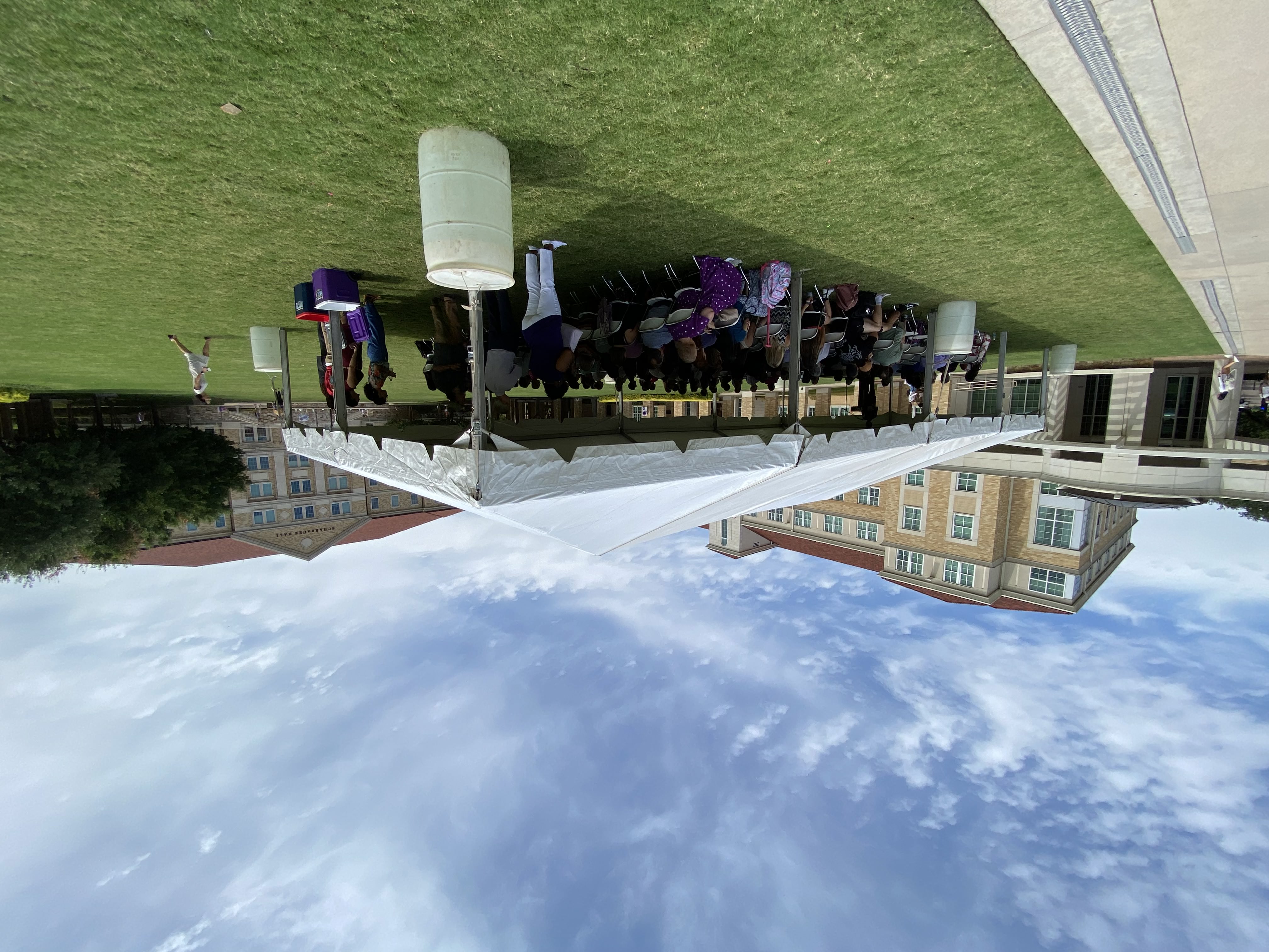 Large tent with people underneath in community commons.