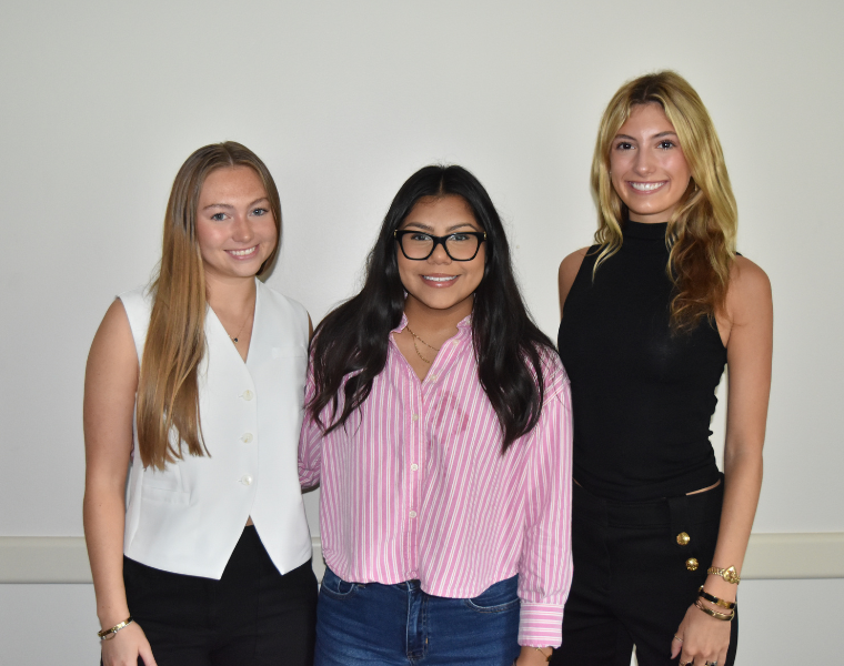 Three Spanish internship students taking a group picture.