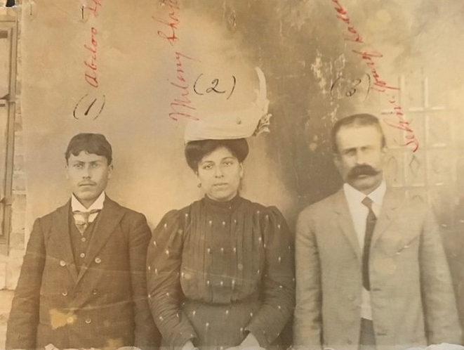 Historical image of three people standing in a row